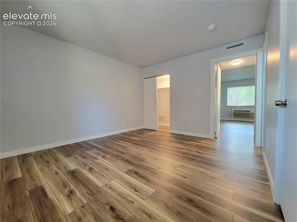 Image 9 of 31: Primary Bedroom featuring wood-finish flooring, and his & hers closet