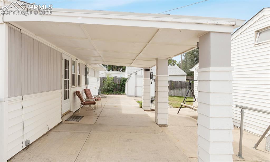 Image 19 of 20: Large covered back patio.
