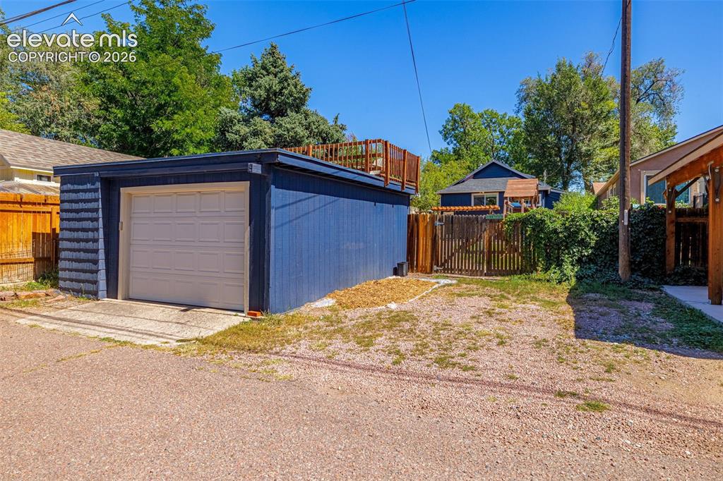 Image 35 of 48: Detached garage with added parking space