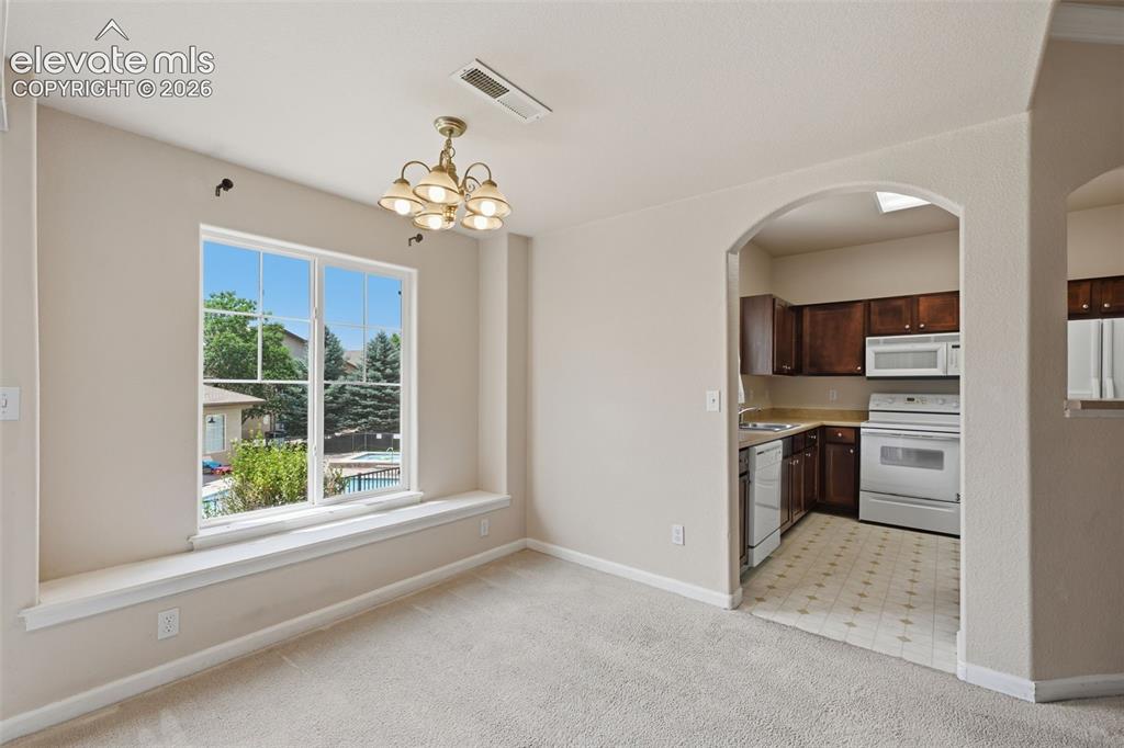 Image 10 of 29: Sitting bench adds versatility to the dining area.