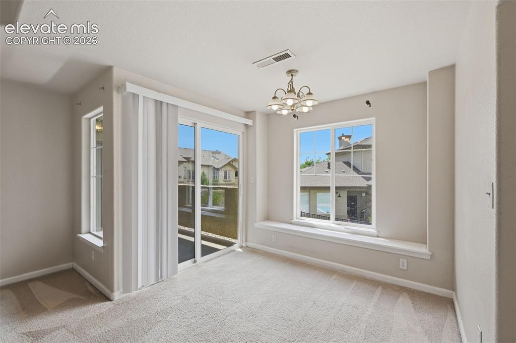 Image 11 of 29: Dining room offers walk-out to enclosed deck. 