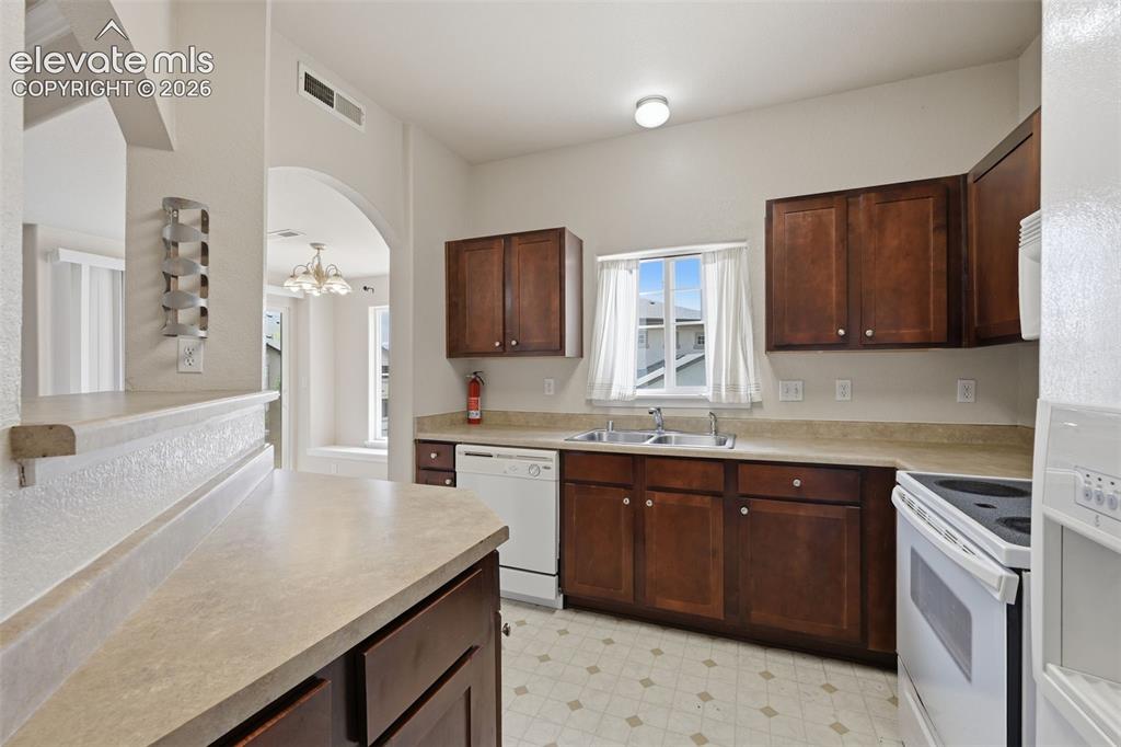Image 13 of 29: Two kitchen openings and the perfectly placed passthrough creates an ideal 