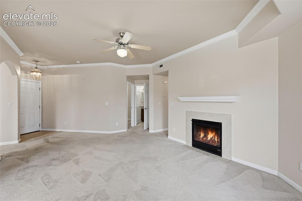 Image 7 of 29: Open living room with fireplace focal point. 