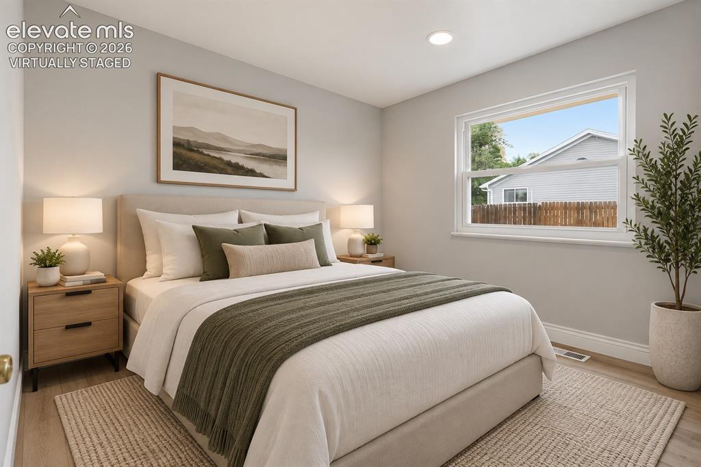 Image 13 of 33: Main Level Bedroom with Laminate Flooring! Virtually staged.