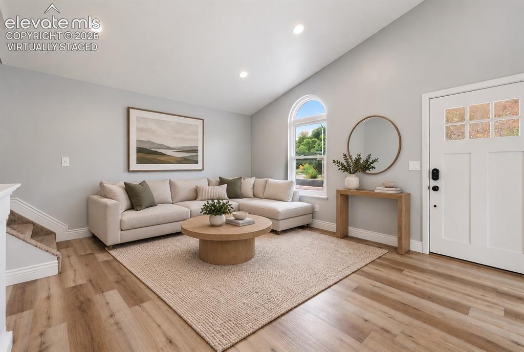 Image 3 of 33: Vaulted Living Room with Laminate Flooring! Virtually staged.