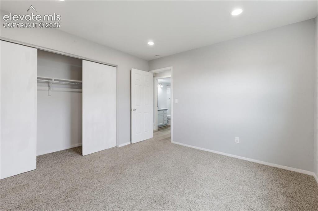 Image 30 of 33: Main Level Bedroom with Carpeting!