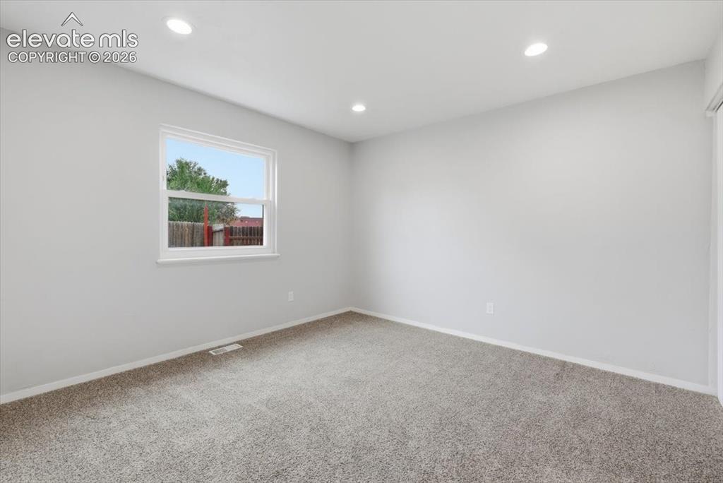 Image 31 of 33: Main Level Bedroom with Carpeting!