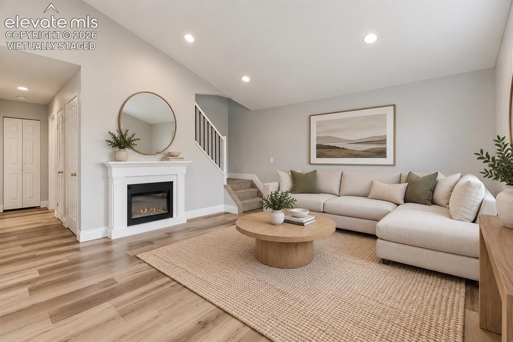 Image 4 of 33: Vaulted Living Room with Laminate Flooring! Virtually staged.