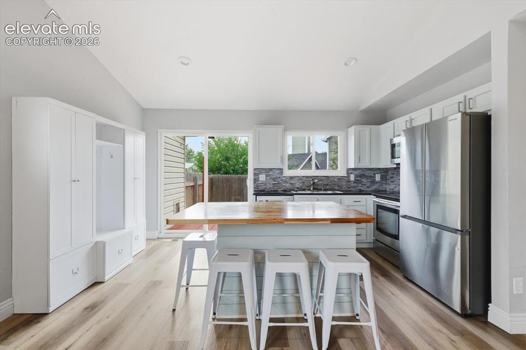 Image 5 of 33: Upgraded Gourmet Kitchen with Granite Countertops, Butcherblock Island, Sta