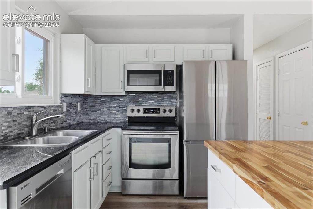 Image 6 of 33: Upgraded Gourmet Kitchen with Granite Countertops, Butcherblock Island, Sta