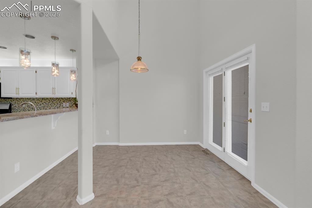 Image 12 of 41: Eat in kitchen area with breakfast bar and walk-out to deck