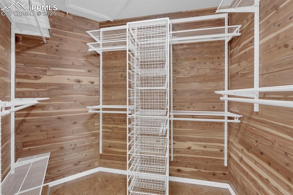 Image 25 of 41: Primary bedroom walk in closet