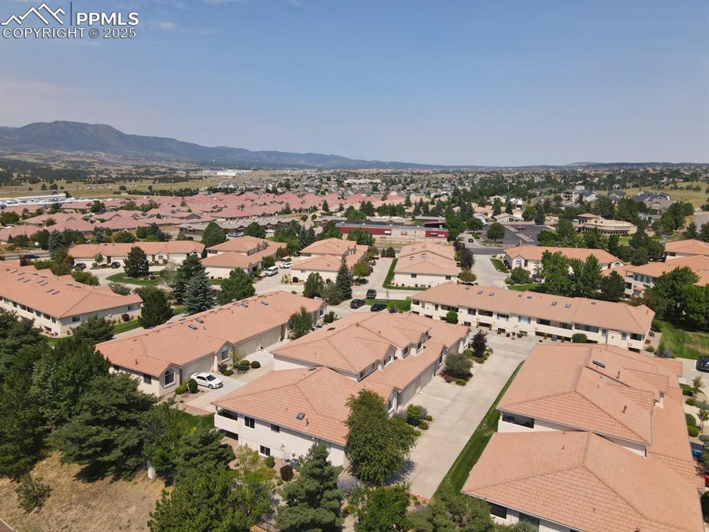 Image 35 of 41: Aerial perspective of suburban area featuring a mountain backdrop