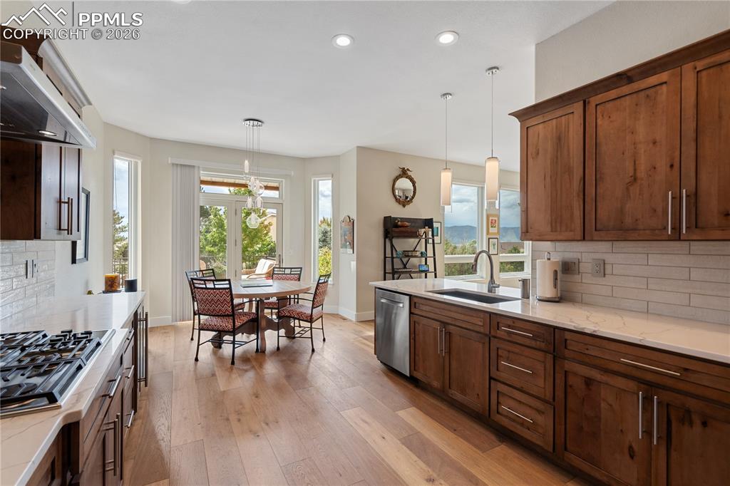 Image 10 of 50: Knotty maple kitchen cabinets with soft close drawers and pull outs