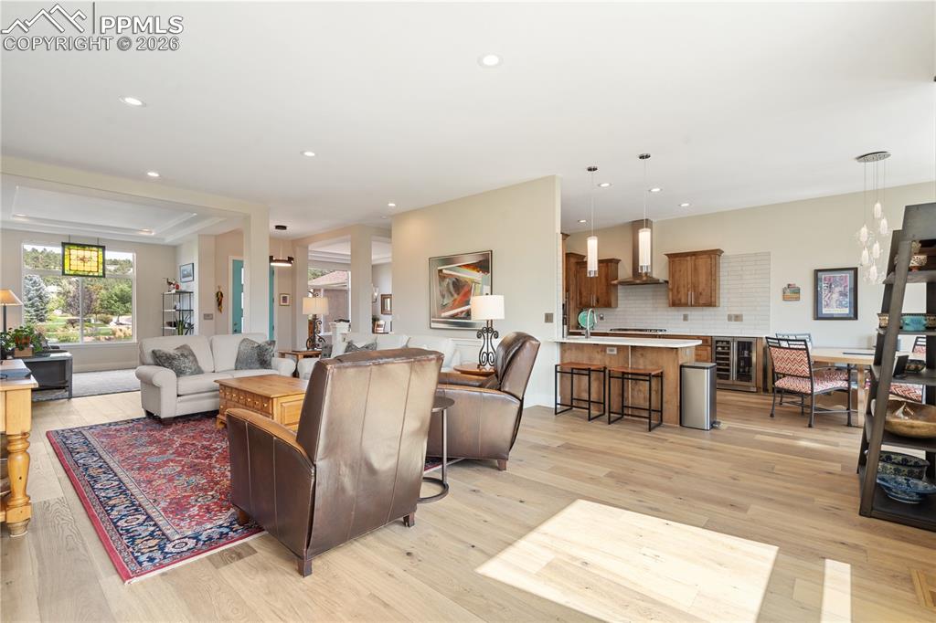 Image 16 of 50: Family room/kitchen has breakfast bar seating