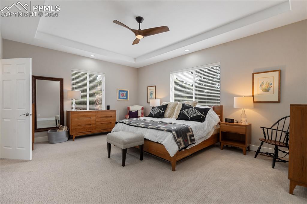 Image 18 of 50: Master bedroom has tray ceiling