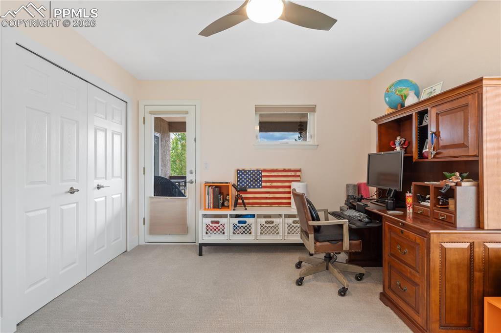 Image 25 of 50: Bedroom on mail level with walk out to enclosed deck