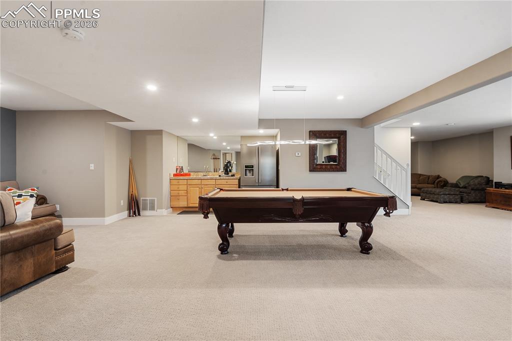 Image 36 of 50: 2nd family room in basement has wet bar
