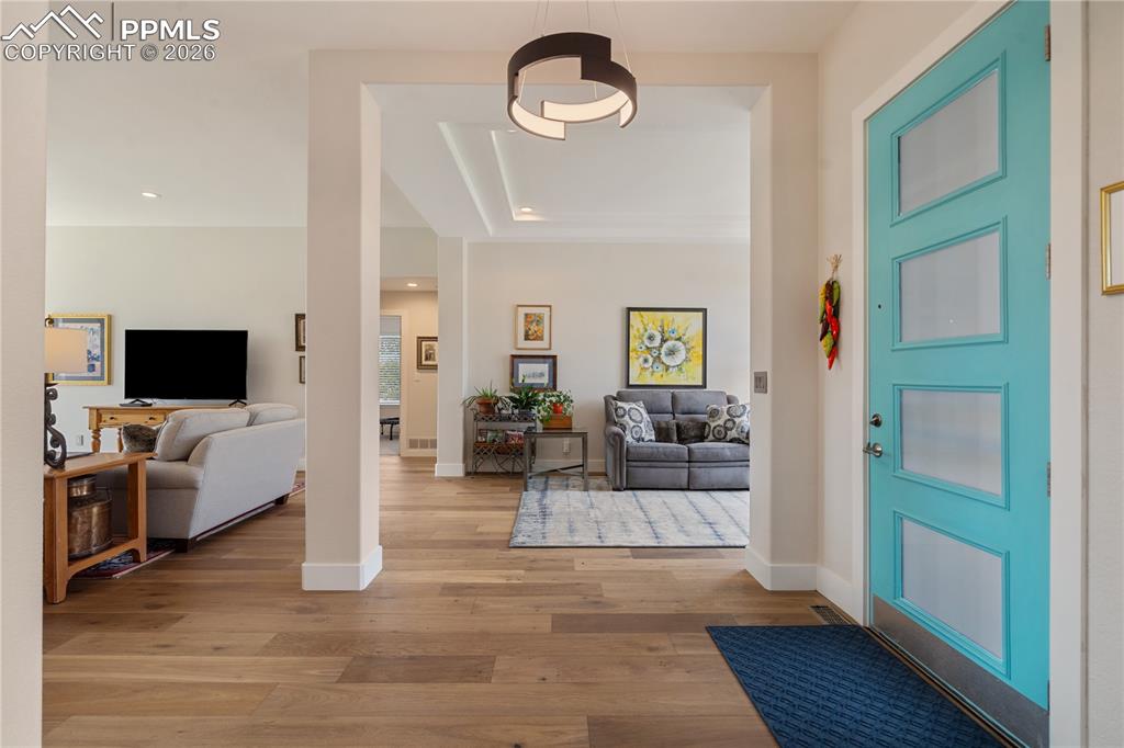 Image 4 of 50: Entry has hardwood floor and door