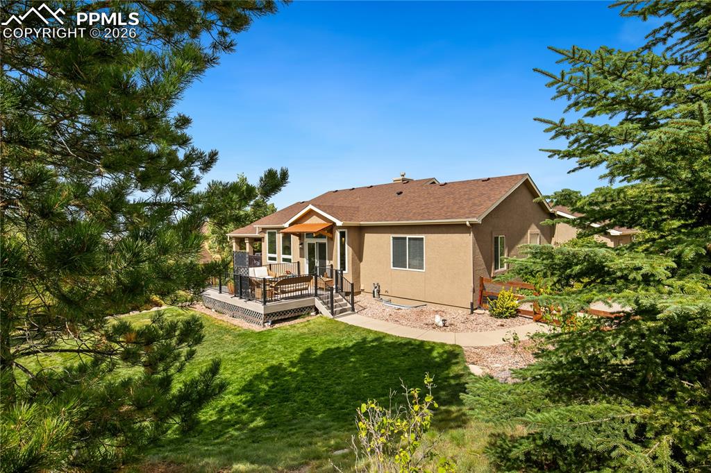 Image 43 of 50: Back view of home with private backyard