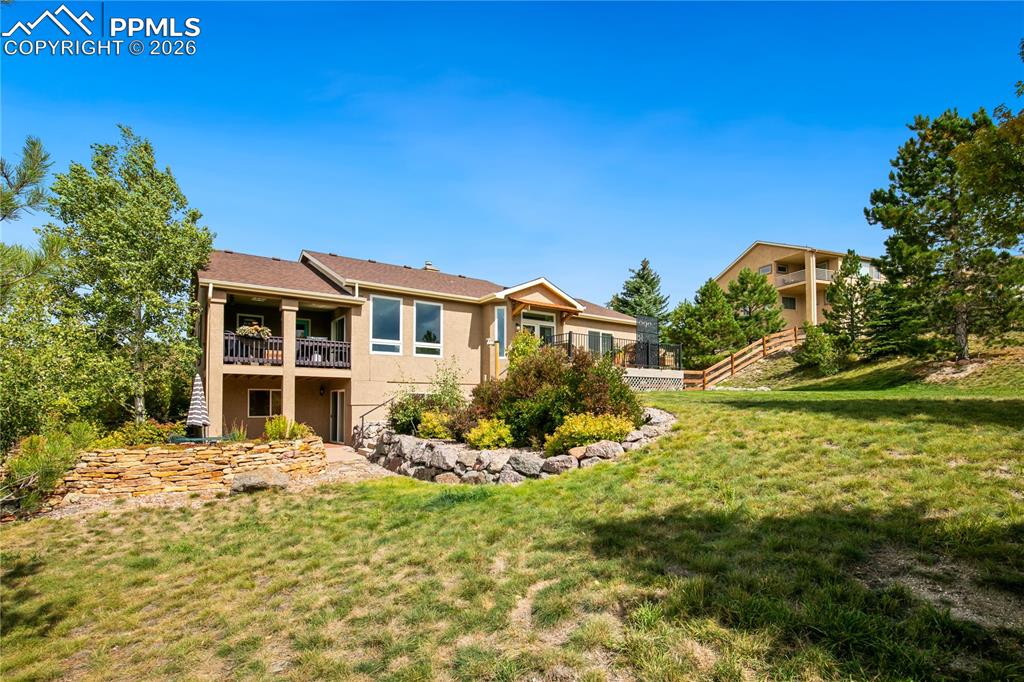 Image 46 of 50: Beautiful low maintenance landscaping in backyard