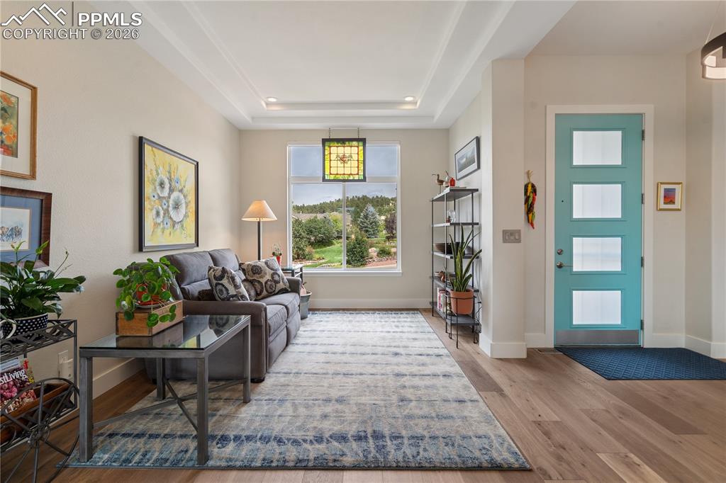 Image 5 of 50: Formal living room with hardwood floor and tray ceiling