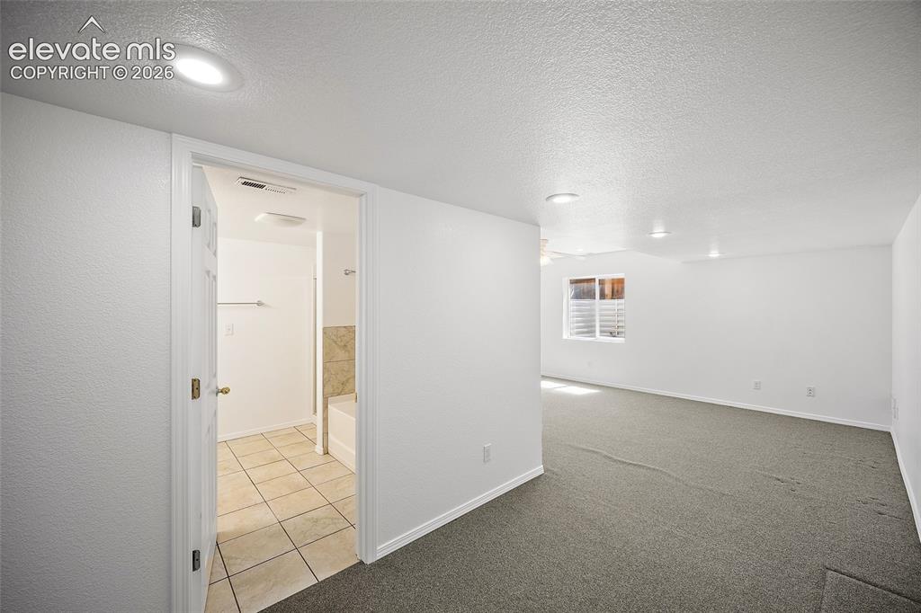 Image 36 of 44: view of bathroom and entertainment/family room in basement