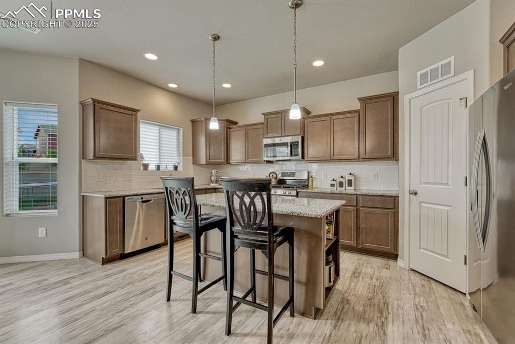 Image 17 of 40: The kitchen also features a large pantry & easy access to the garage 