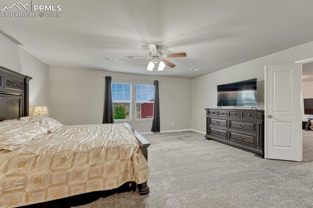 Image 22 of 40: Double doors lead to the primary suite from the loft