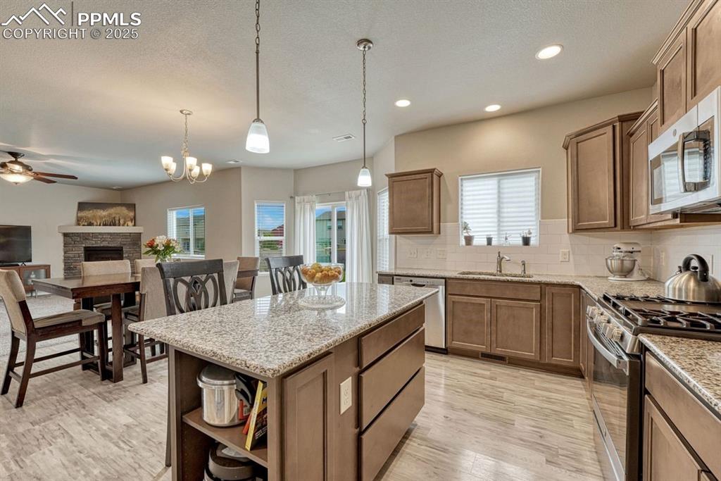 Image 3 of 40: Open floor plan flows easily from the great room, dining room into the kitc