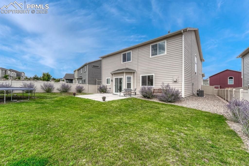 Image 32 of 40: The level backyard offers options for putting your green thumb to work - or