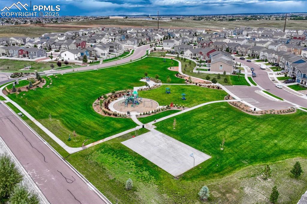 Image 37 of 40: Complete with a sports court and playground, walking trails and expansive v