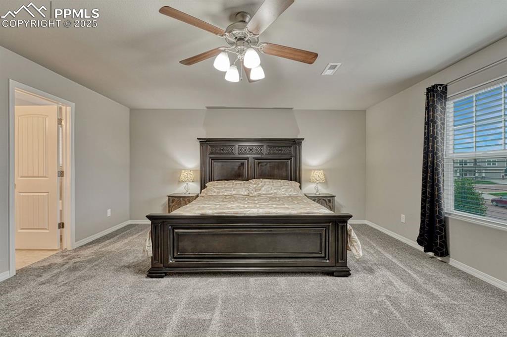 Image 4 of 40: Upstairs, the primary suite is spacious and gets lovely morning light