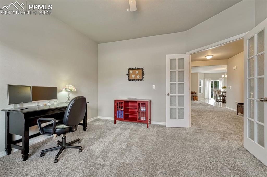 Image 8 of 40: The front room with French doors on the main level offers multiple ways to 