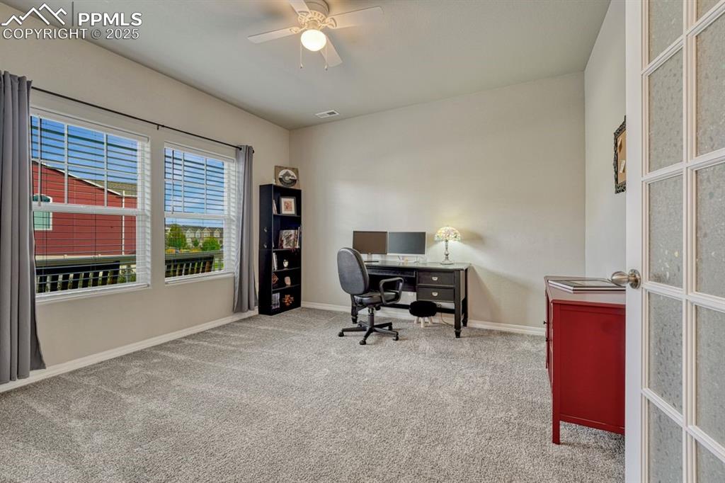 Image 9 of 40: Whether an office or bedroom, this spacious room has wonderful light stream