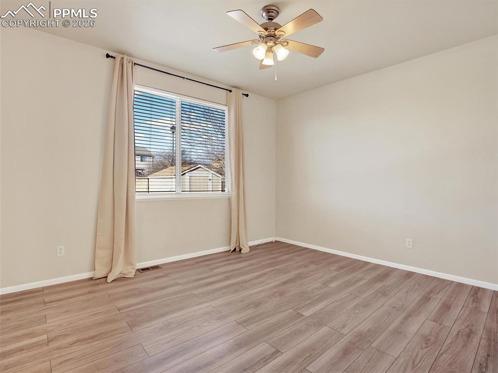Image 21 of 49: Primary bedroom and ceiling fan