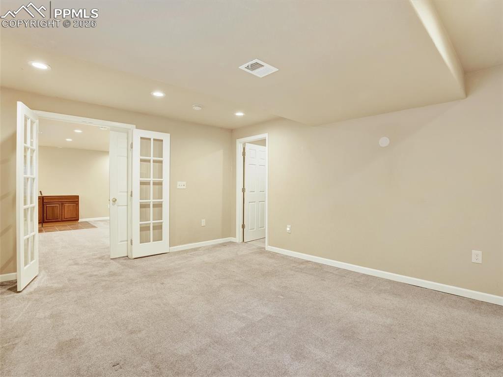 Image 32 of 49: Basement Jr Primary suite with French doors