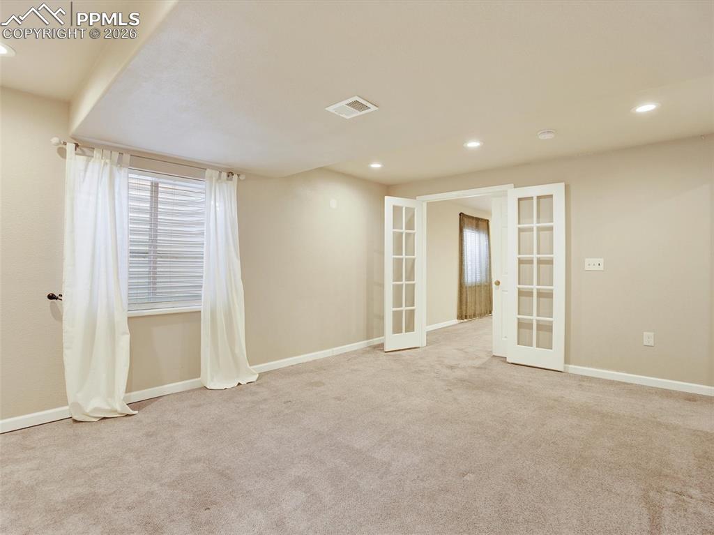Image 33 of 49: Basement Jr Primary suite with French doors
