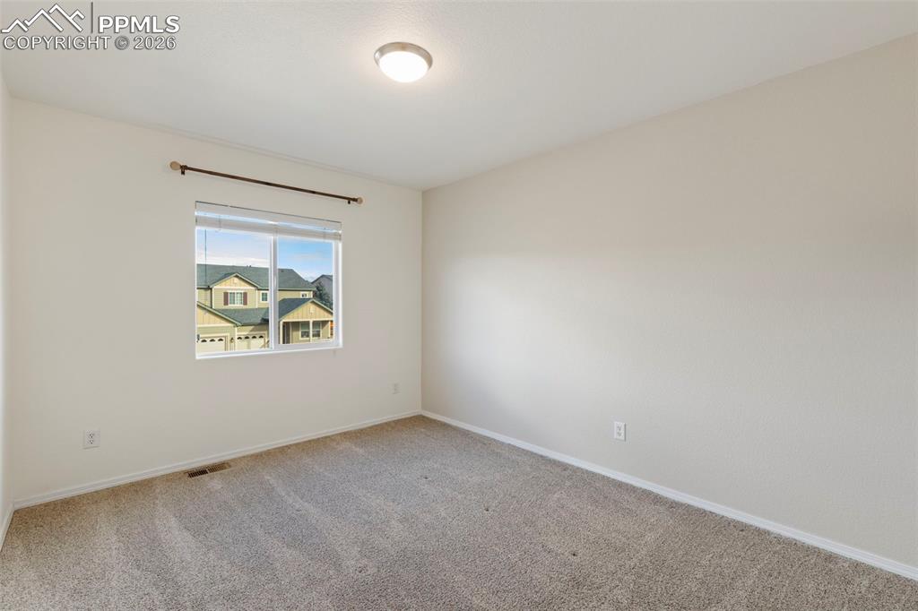 Image 18 of 31: Unfurnished room featuring baseboards and carpet