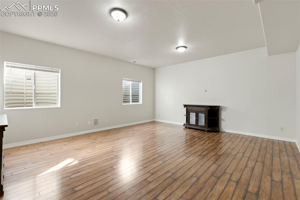 Image 21 of 31: Unfurnished living room featuring wood finished floors