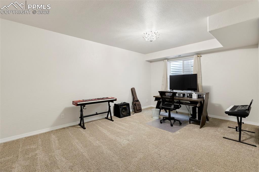 Image 24 of 31: Office with light colored carpet and a textured ceiling
