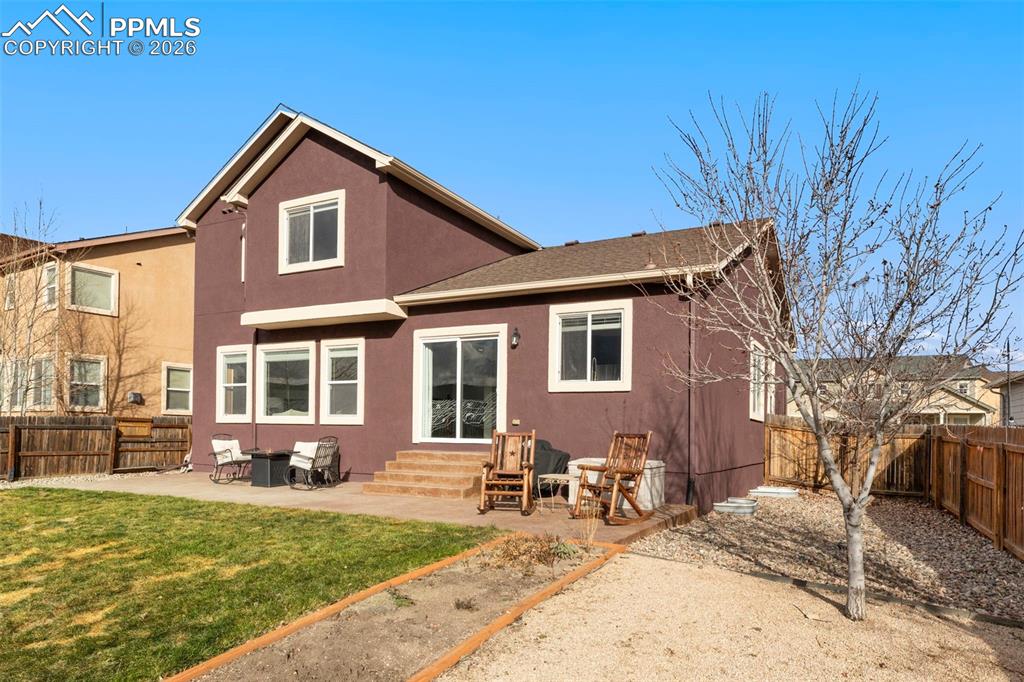Image 27 of 31: Rear view of property with a fenced backyard, a patio, stucco siding, entry