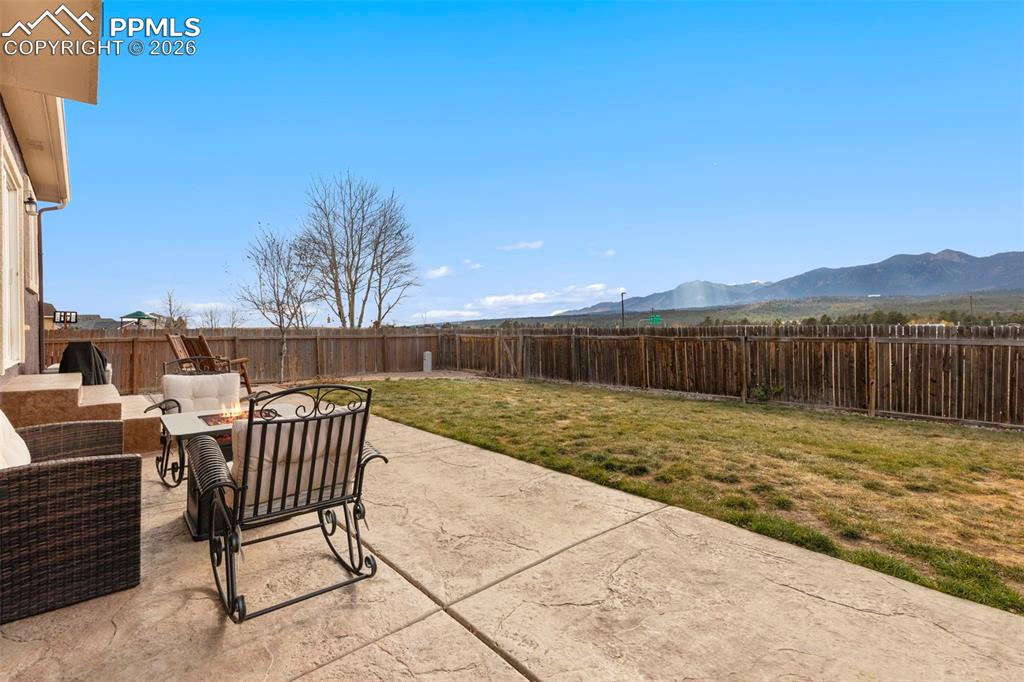 Image 4 of 31: Fenced backyard with mountain views