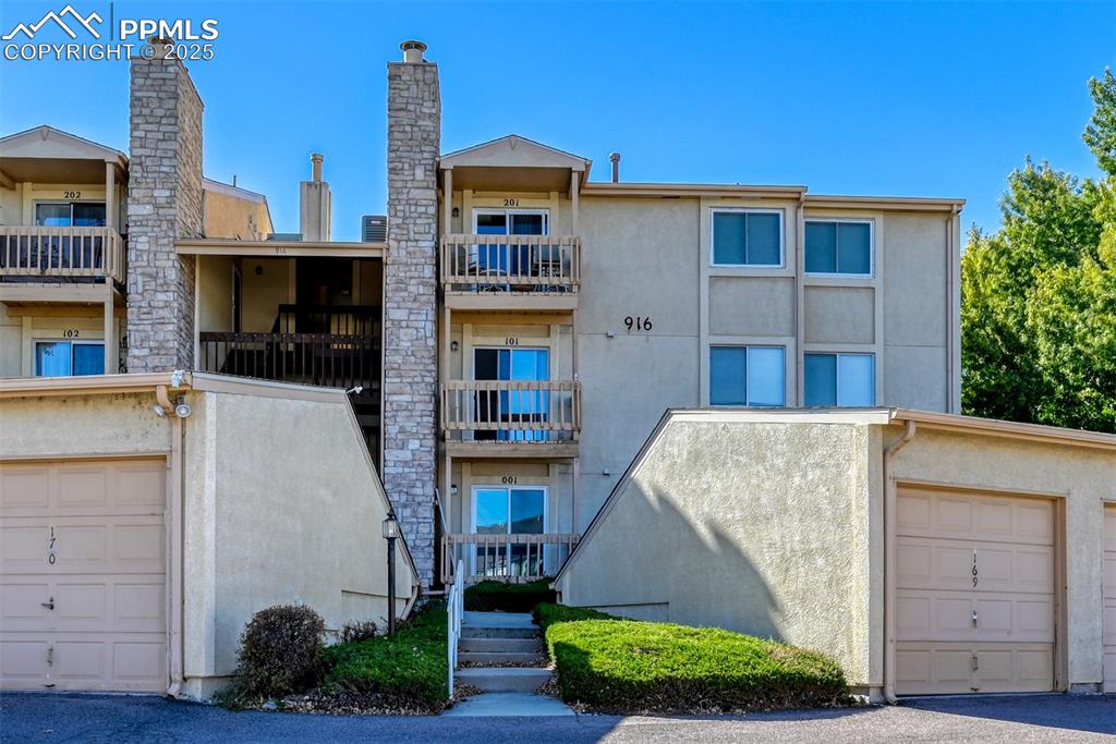 Image 2 of 42: View of apartment building / complex featuring a garage