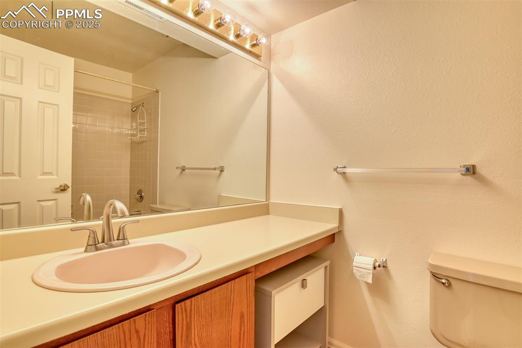 Image 34 of 42: Full bathroom with vanity, shower / tub combination, and a textured wall