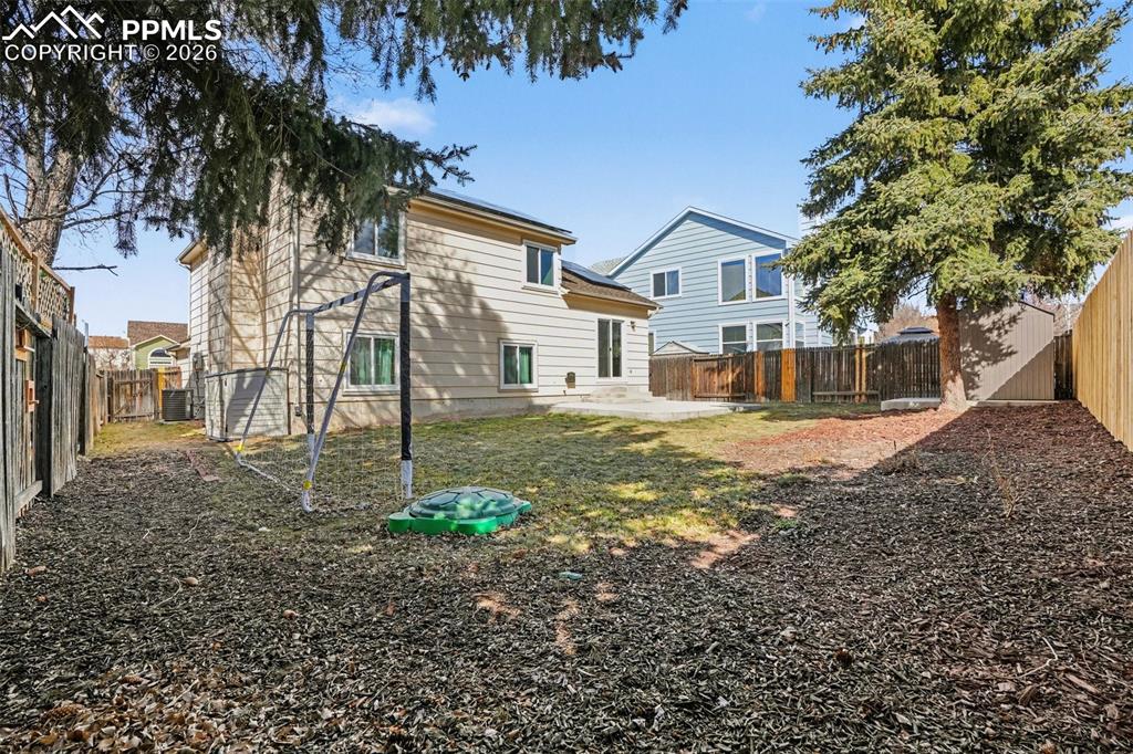Image 19 of 20: Back of property featuring a fenced backyard and a patio