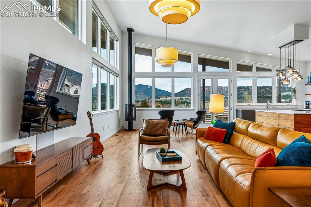 Image 10 of 50: Great room with an open floorplan and solid oak flooring, custom windows &