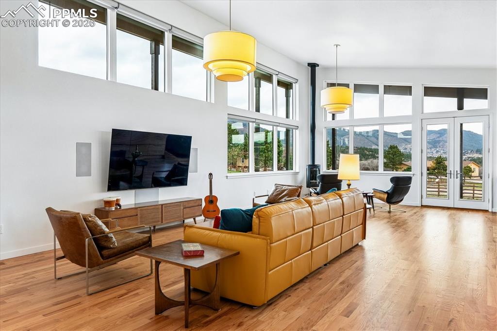 Image 11 of 50: Great room with an open floorplan and solid oak flooring, custom windows &