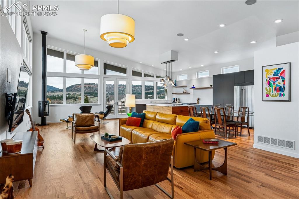 Image 12 of 50: Great room with an open floorplan and solid oak flooring, custom windows &