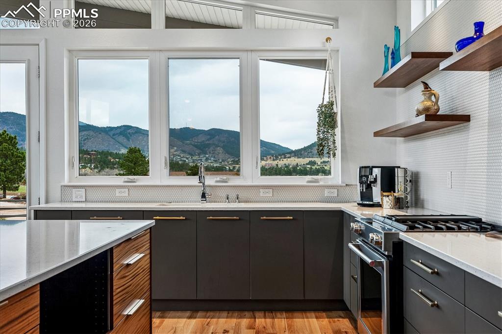 Image 17 of 50: Gourmet kitchen with solid oak flooring, mountain views, designer & recesse